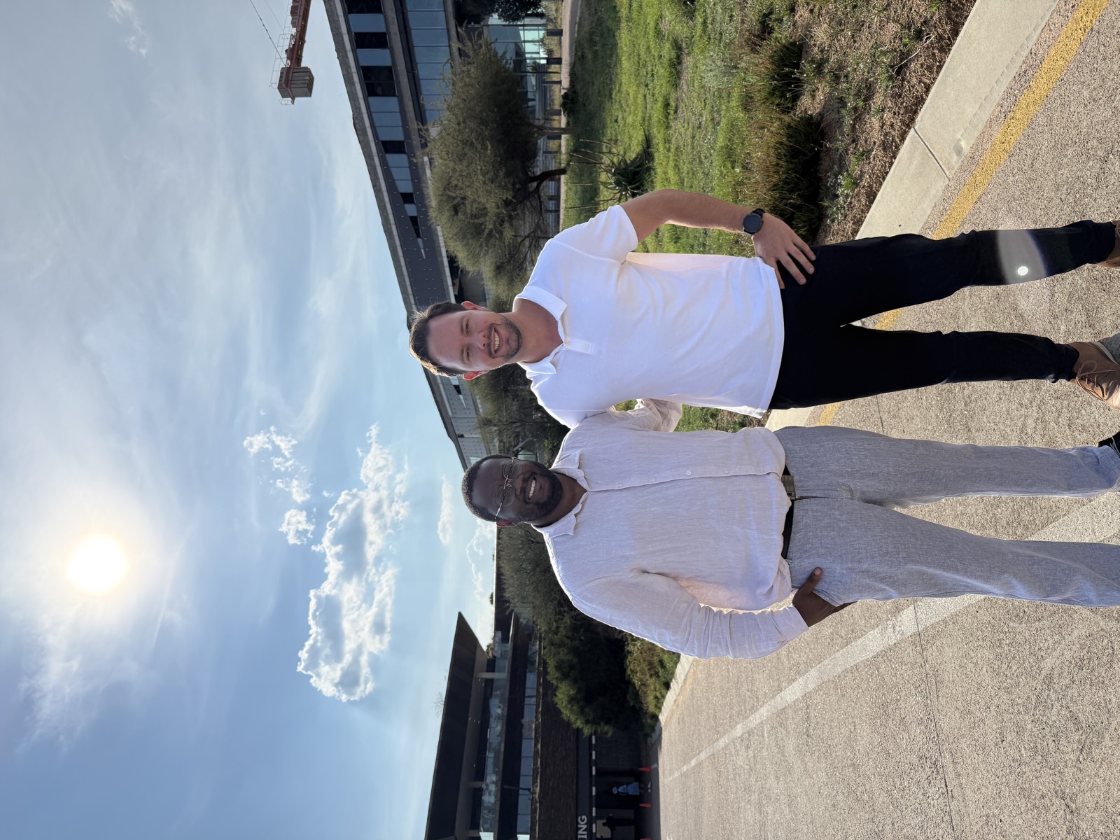 PatientCare co-founders Jesse Liula Schiceya and Phillip Theissen standing outside modern office buildings in Gaborone, Botswana